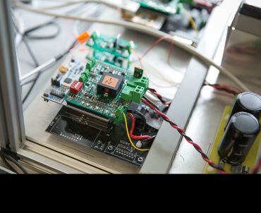 Close up of the components of a battery on a lab bench.
