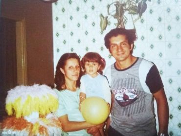 This old photo shows Prof Ferreira as a child in the middle, with her parents on either side - courtesy of Daniela Ferreira