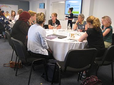 women sitting at a table at an event