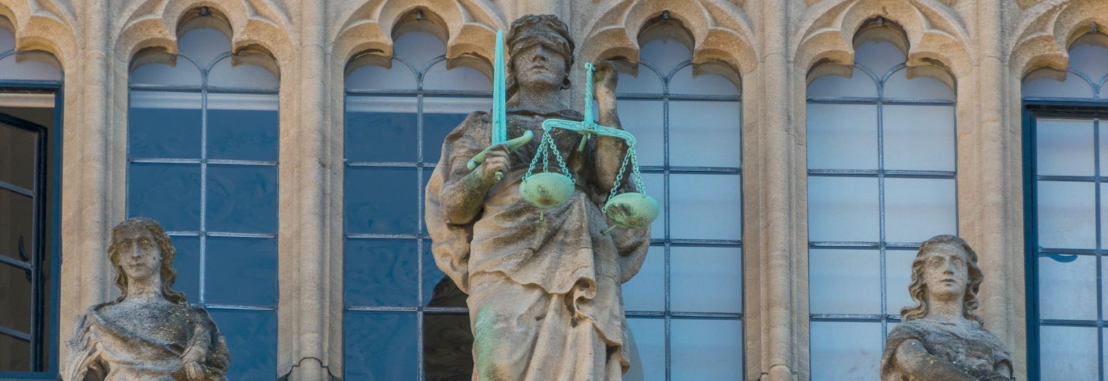 Detail of the façade of the Bodleian Library in Oxford showing Justice with her scales and blindfold.
