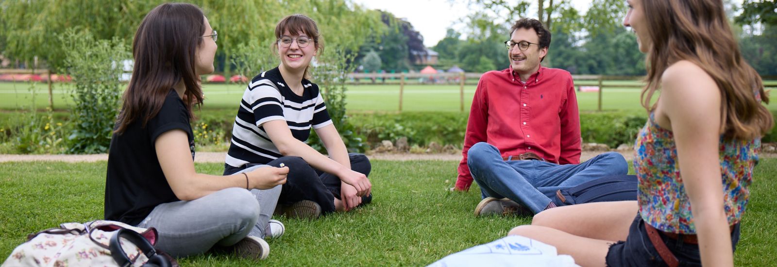 Students sat talking in the Botanic Gardens, Ian Wallman Photography. 