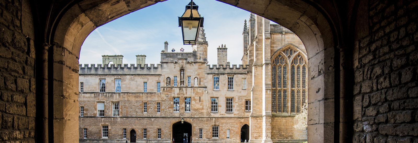 A quad through an arch at New College