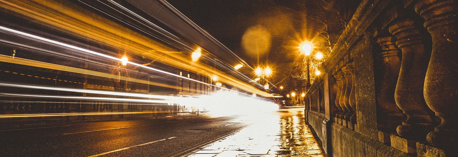 Lights from passing traffic on Magdalen Bridge at night
