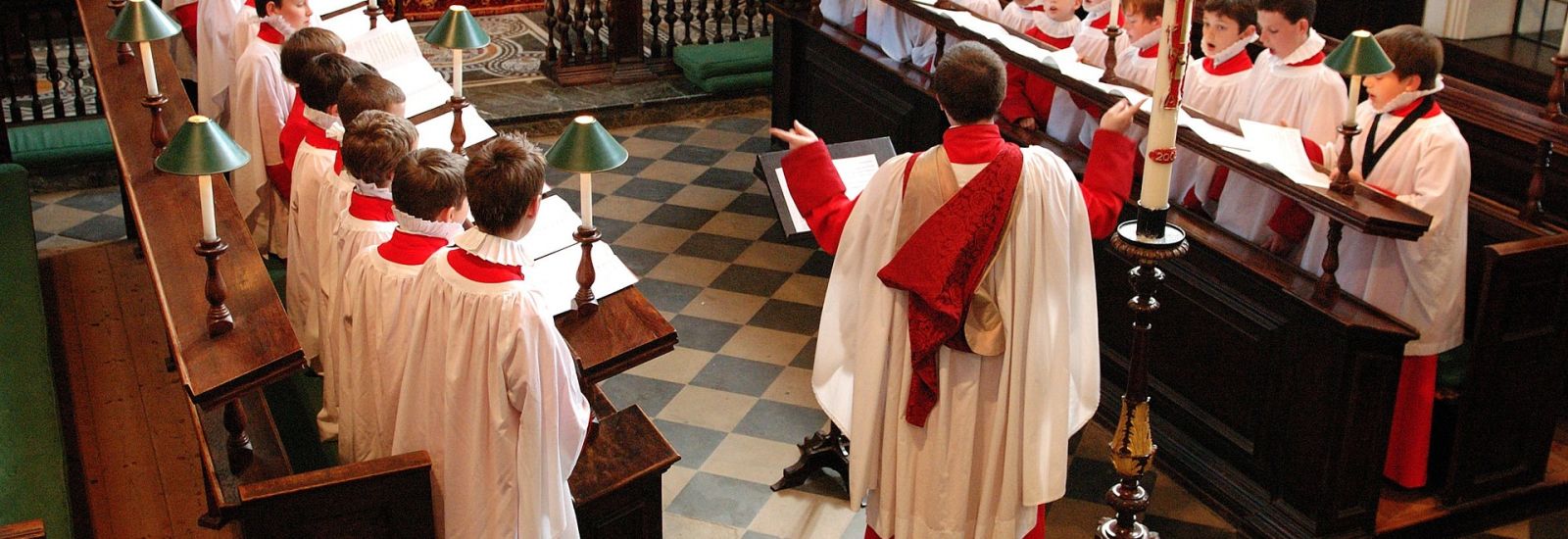 boys in robes singing in a church