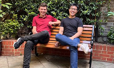 two men sitting on bench