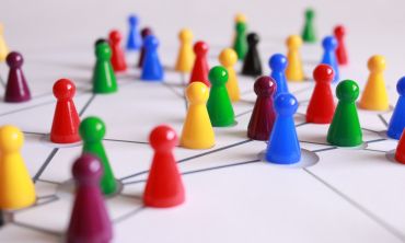 Lots of multi-coloured playing pieces are connected by a network of lines