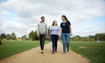 Three students walking in University Parks