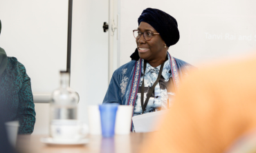 a smiling adult sitting at a table
