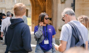 An Oxford student ambassador giving directions at an Open Day