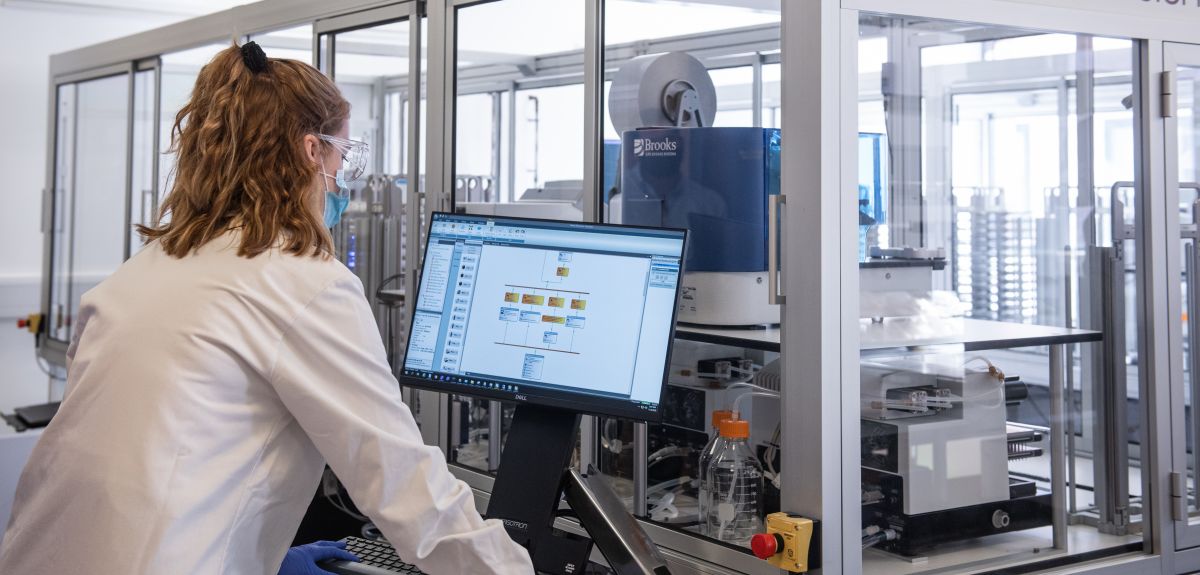 Female scientists using the serology machine