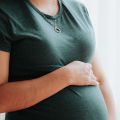 a pregnant woman holding her tummy